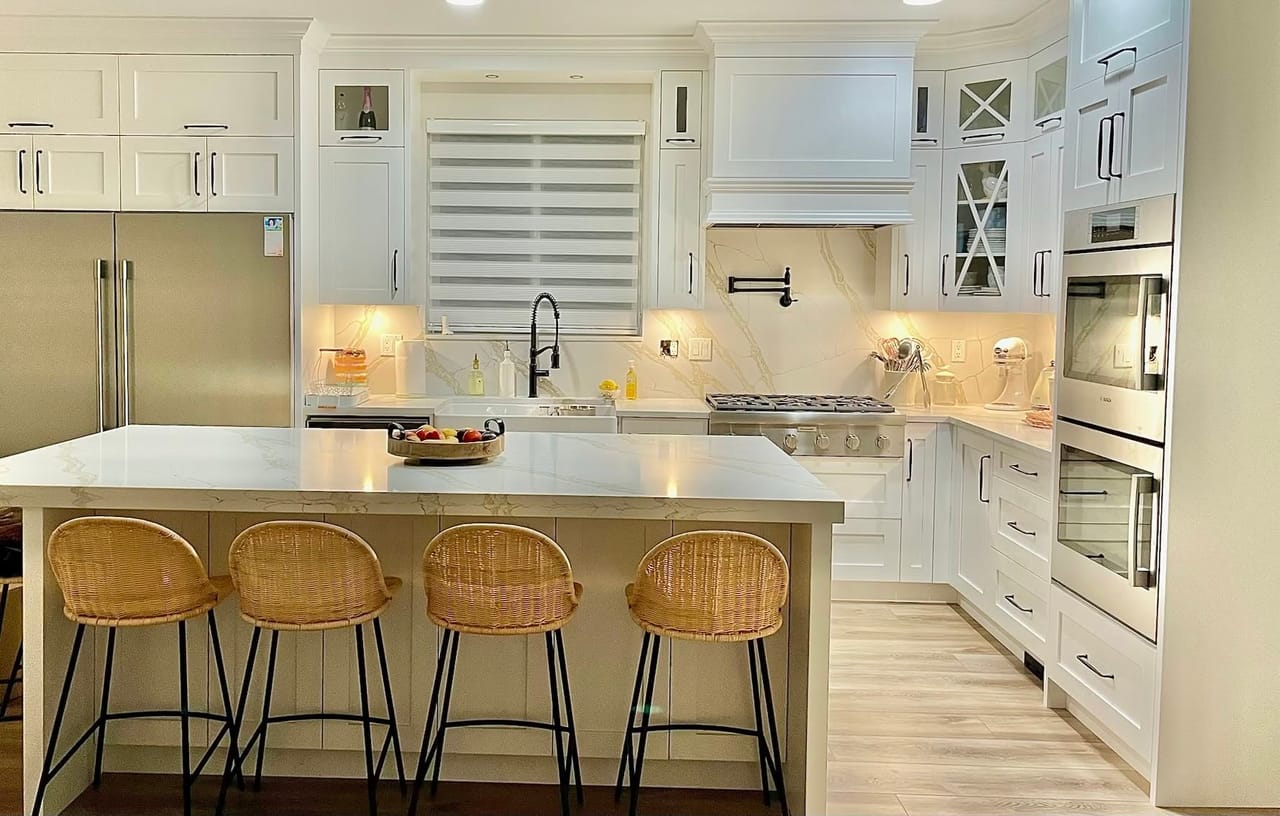 Custom white shaker kitchen with marble island and backsplash built by Roccot